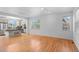Bright and airy living room featuring hardwood floors, with the kitchen in the background at 701 N Roslyn St # 36, Denver, CO 80230
