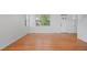 Minimalist living room featuring hardwood floors, neutral walls, and large windows at 701 N Roslyn St # 36, Denver, CO 80230