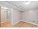 Unfinished basement area with wood flooring and utility access, ready for customization at 2606 W Alamo Ave, Littleton, CO 80120