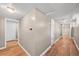 Hallway in basement features wood floors and doors to other rooms in the basement at 2606 W Alamo Ave, Littleton, CO 80120