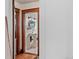 Small bathroom with pedestal sink is bright and cheery, with a view from the hallway at 2606 W Alamo Ave, Littleton, CO 80120