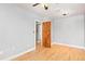 Bright bedroom with neutral walls, light hardwood floors, and a ceiling fan at 2606 W Alamo Ave, Littleton, CO 80120