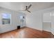 This bedroom has hardwood floors, a ceiling fan, and a cozy window at 2606 W Alamo Ave, Littleton, CO 80120