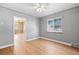 Cozy bedroom with hardwood floors, ceiling fan, and large window for natural light at 2606 W Alamo Ave, Littleton, CO 80120