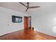 Bedroom with original hardwood floors and white walls, complemented by modern ceiling fan at 2606 W Alamo Ave, Littleton, CO 80120