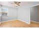 Cozy bedroom featuring light hardwood floors and a ceiling fan, offering comfort and style at 2606 W Alamo Ave, Littleton, CO 80120