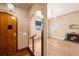 Inviting entryway with hardwood floors leading into living space with fireplace at 2606 W Alamo Ave, Littleton, CO 80120