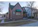 Quaint brick building featuring green awnings and a chimney, exudes classic charm and curb appeal at 2606 W Alamo Ave, Littleton, CO 80120