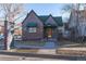 Charming brick building with a green roof and awnings near a community sign at 2606 W Alamo Ave, Littleton, CO 80120