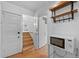 Hallway with hardwood floors that leads up to the second level with a storage shelf and microwave at 2606 W Alamo Ave, Littleton, CO 80120