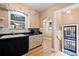 Well lit kitchen with stainless appliances, wood cabinets, a microwave, and a double basin sink under the window at 2606 W Alamo Ave, Littleton, CO 80120