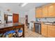 Traditional kitchen features light wood cabinets, a rolling island, and tile flooring at 2606 W Alamo Ave, Littleton, CO 80120