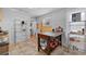 Bright kitchen features a work table and storage for kitchen goods, with tiled floor and stainless shelves at 2606 W Alamo Ave, Littleton, CO 80120