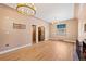 Elegant living room featuring hardwood floors, chandelier lighting, and neutral wall tones at 2606 W Alamo Ave, Littleton, CO 80120