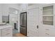 Open kitchen area with stainless steel refrigerator and white cabinets at 288 S Sherman St, Denver, CO 80209