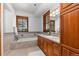 Elegant bathroom with soaking tub, double vanity, and tile flooring at 9977 Elkhorn St, Littleton, CO 80127