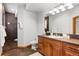 Modern bathroom with a large shower, tile flooring, and wooden vanity at 9977 Elkhorn St, Littleton, CO 80127