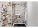 Modern bathroom with marble shower, window, and a sleek design at 9977 Elkhorn St, Littleton, CO 80127