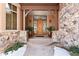Inviting entryway with double doors, stone accents, and potted plants at 9977 Elkhorn St, Littleton, CO 80127