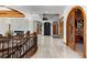 Two-story entryway with a curved staircase, marble floors, and a water feature at 9977 Elkhorn St, Littleton, CO 80127