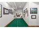 Long putting green with golf artwork on the walls at 9977 Elkhorn St, Littleton, CO 80127