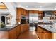 Updated kitchen features wood cabinetry and granite countertops at 9977 Elkhorn St, Littleton, CO 80127
