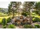 Serene backyard water feature with lush landscaping and natural rock formations at 9977 Elkhorn St, Littleton, CO 80127