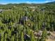Expansive aerial view showcasing the property nestled among lush greenery, providing privacy and a tranquil setting at 44 Linn Ln, Golden, CO 80403
