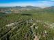 Stunning aerial view of property nestled among lush greenery with mountains in the background at 44 Linn Ln, Golden, CO 80403