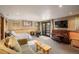 Spacious basement with bedroom area, sitting area, piano, and access to the exterior at 44 Linn Ln, Golden, CO 80403