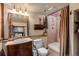 Bathroom with vintage vanity, decorative mirror, and shower with a curtain at 44 Linn Ln, Golden, CO 80403
