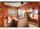 Bathroom with bold wallpaper, wooden trim, a framed mirror, and a toilet at 44 Linn Ln, Golden, CO 80403