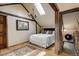 Cozy bedroom with a wood beam ceiling, skylight, wood floors, and a comfortable bed at 44 Linn Ln, Golden, CO 80403