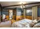 Cozy bedroom with a wood-trimmed window, a queen bed, and an ensuite bathroom at 44 Linn Ln, Golden, CO 80403