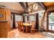 Cozy dining room with hardwood floors, wood beams, large windows, and a wooden table with seating for six at 44 Linn Ln, Golden, CO 80403