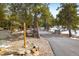 Scenic driveway leads to a charming log cabin surrounded by trees at 44 Linn Ln, Golden, CO 80403