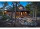 Charming log home featuring a welcoming front porch and a beautifully landscaped yard with natural rock features at 44 Linn Ln, Golden, CO 80403