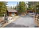 A separate shop/garage with a large window is adjacent to the driveway of this secluded mountain home at 44 Linn Ln, Golden, CO 80403