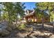 Inviting exterior with a spacious porch, ideal for relaxing and enjoying the serene, wooded surroundings at 44 Linn Ln, Golden, CO 80403