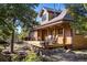 Inviting front porch with rocking chairs, beautiful carved pillars, and natural wood accents at 44 Linn Ln, Golden, CO 80403