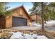 Large detached garage near home in a picturesque setting with natural landscaping and winter snow at 44 Linn Ln, Golden, CO 80403