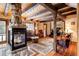 Comfortable living room with stone fireplace, wood flooring, and rustic beams at 44 Linn Ln, Golden, CO 80403