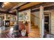 Cozy living room showcasing stone fireplace, tile floors, staircase, and rustic wood accents at 44 Linn Ln, Golden, CO 80403