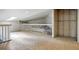 A spacious unfinished attic area with plywood flooring, exposed ductwork and a white railing at 19640 Four Winds Way, Monument, CO 80132