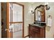 Classic bathroom features elegant vanity, sconces and decorative mirror at 19640 Four Winds Way, Monument, CO 80132