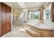 Bright bathroom with soaking tub, glass shower, and tiled surround at 19640 Four Winds Way, Monument, CO 80132