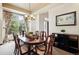 Elegant dining room features large window, chandelier, and seating for six at 19640 Four Winds Way, Monument, CO 80132