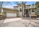 Contemporary home showcasing a front entrance with red accents and a spacious two-car garage at 19640 Four Winds Way, Monument, CO 80132