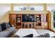 Living room featuring a large, wooden entertainment center with glass door storage at 19640 Four Winds Way, Monument, CO 80132