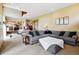 Open-concept living area with staircase, gray sectional sofa and recessed lighting at 19640 Four Winds Way, Monument, CO 80132